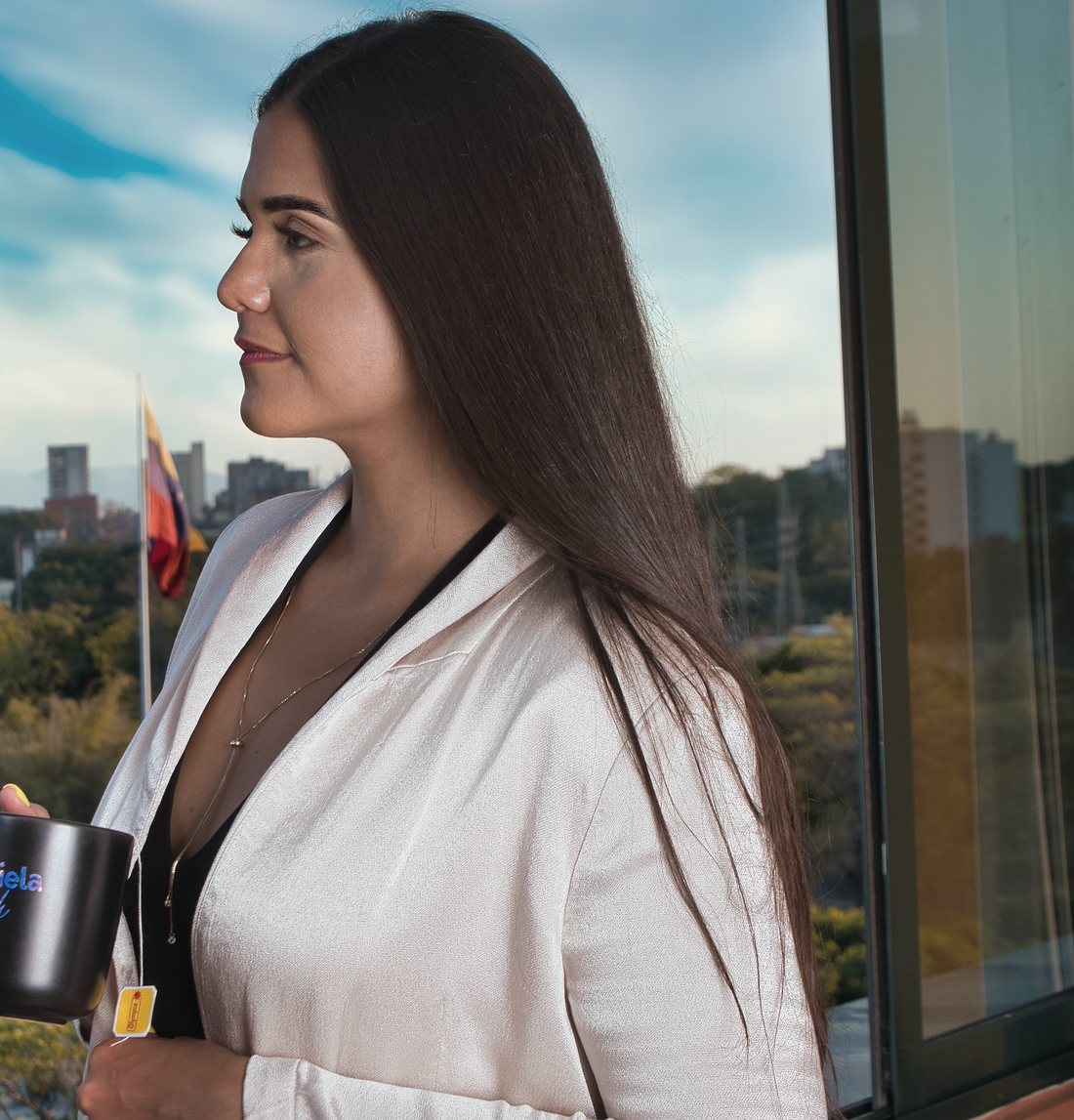 Gabriela Biscardi looking across the city from a window