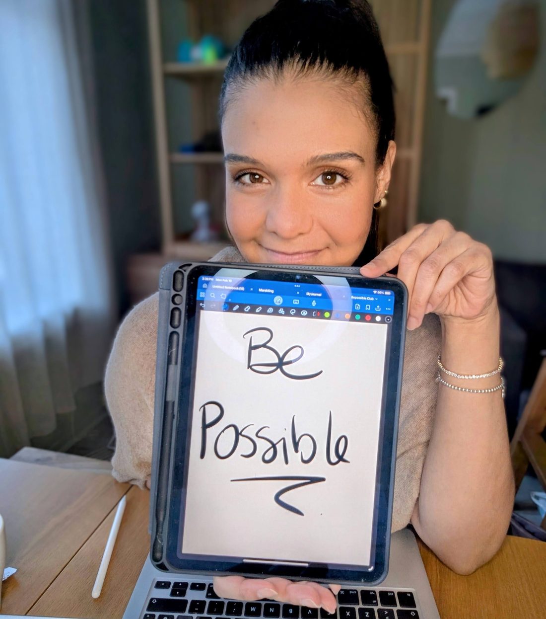 Gabriela Biscardi holding a handwritten Be Possible sign